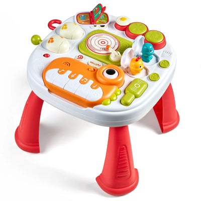 7-in-1 dinosaur-themed baby activity table with bright colors, featuring interactive toys such as a mini piano, dinosaur eggs, flip-up book, sound and light buttons, spinning disc, and drum pads on the tabletop. The table has removable red legs and older to encourage hand-eye coordination, and creativity.