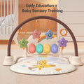 Baby sensory play gym with soft giraffe-themed mat, colorful star-shaped hanging toys, and illuminated musical buttons, designed for early education and sensory development in a cozy nursery setting.