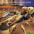 Dinosaur-themed racetrack toy set featuring a dino fossil transport truck with a ramp, surrounded by miniature fossil dinosaur figures, bridges, palm tree props, and a battery-powered dino car ascending the ramp—designed to inspire children’s curiosity about fossils.