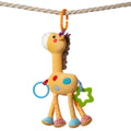 A plush hanging giraffe baby toy with colorful spots, textured legs, and attached teething rings, suspended by an orange clip on a rope.