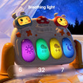 A close-up of the baby play gym’s control panel glowing at night. Four large illuminated keys display icons (sun, rain, lightning, moon) in purple, green, yellow, and blue colors. Above are two cartoon bunny heads and a mushroom-shaped speaker. Text overlay reads: “Breathing light – 6 LED light sources, 32 changing lighting effects, 7 natural colors.” A starry night sky is visible in the background.