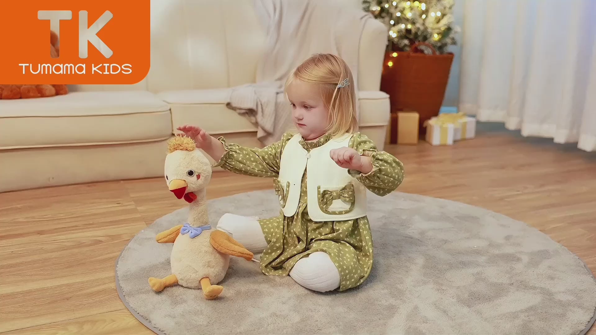 little girl plays with this stuffed chick toy taht wriggles and retells