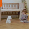 little girl playing with battery operated toy dog that walks and barks
